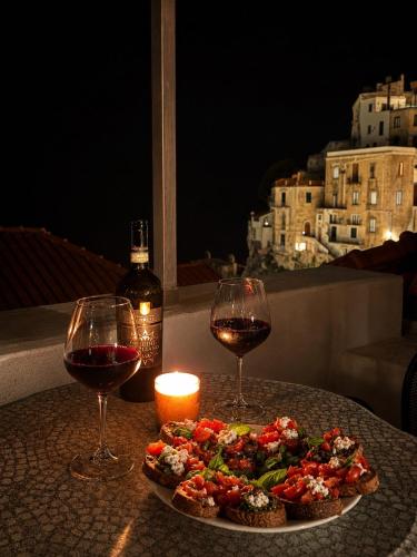 a plate of food and two glasses of wine on a table at Luna Rossa in Minori