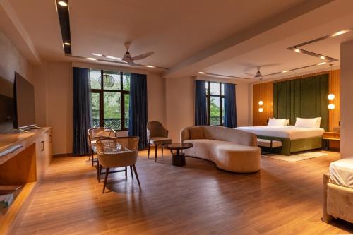 a hotel room with a bed and a living room at IFQ Premier Skardu in Skardu