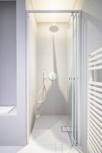a room with a shower and a glass door at Marea Boutique Hotel in Orosei