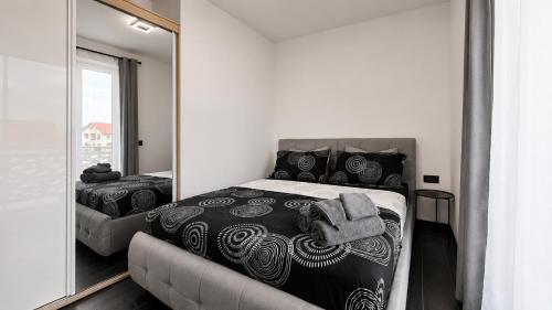 a bedroom with a bed and a large mirror at Art Suite - Private Parking in Oradea
