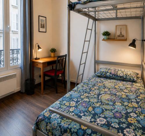 a bedroom with a bed and a desk with a ladder at Studio Maisons-Alfort in Maisons-Alfort