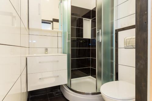 a bathroom with a toilet and a glass shower at The heart of Dubrovnik in Dubrovnik