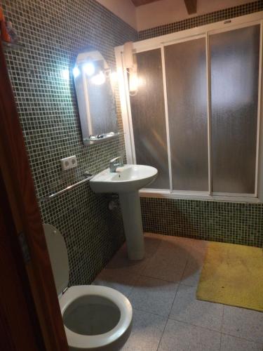 a bathroom with a toilet and a sink at Residencia Santiago Mallorca in Cala Figuera