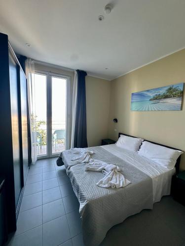 a bedroom with a bed with towels on it at hotel Torretta Bramante in Rimini
