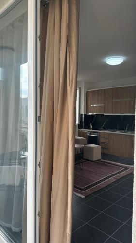 a view of a kitchen with a curtain at Tale Coast Apartments in Tale