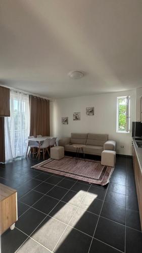 a living room with a couch and a table at Tale Coast Apartments in Tale