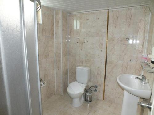 a bathroom with a toilet and a sink at Blue Garden Family Side in Side