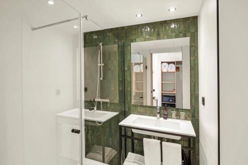 a bathroom with two sinks and a mirror at Tangerine by Honne Hotels - Adults Only in Magaluf