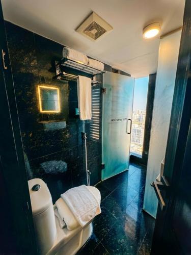 a bathroom with a toilet and a shower at Elite Hotel Airport in Dhaka