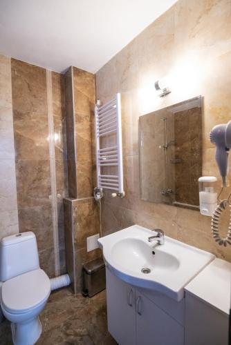 a bathroom with a white sink and a toilet at Студио in Starosel