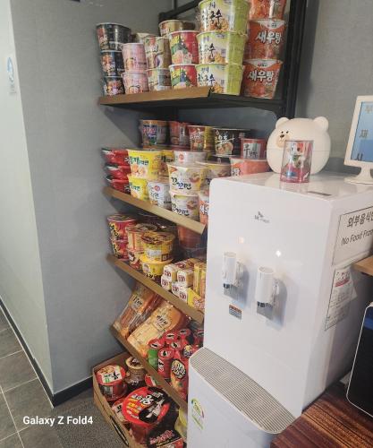 a refrigerator in a room with food on a shelf at GoodDay Jjimjilbang in Incheon