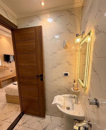 a bathroom with a sink and a mirror at Via Cairo hotel in Cairo