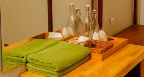 a table with green towels and bottles on it at Kep Orchid Cafe in Phumĭ Dâmnăk Châng'aeur
