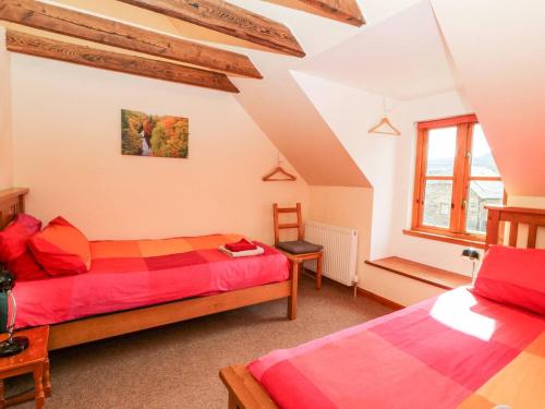 a bedroom with two beds in a attic at Elm Cottage in Aberfeldy