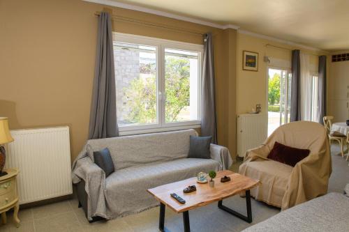 a living room with a couch and a table at Anasa Villas in Mythimna