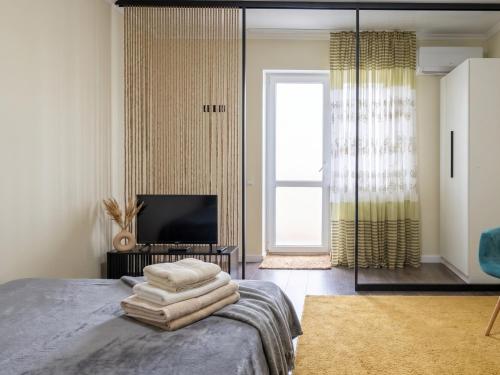 a bedroom with a bed with towels on it at new stail centr in Bălţi