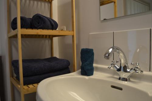 a bathroom with a sink and a mirror and towels at Château d'Harnoy in Yvoir