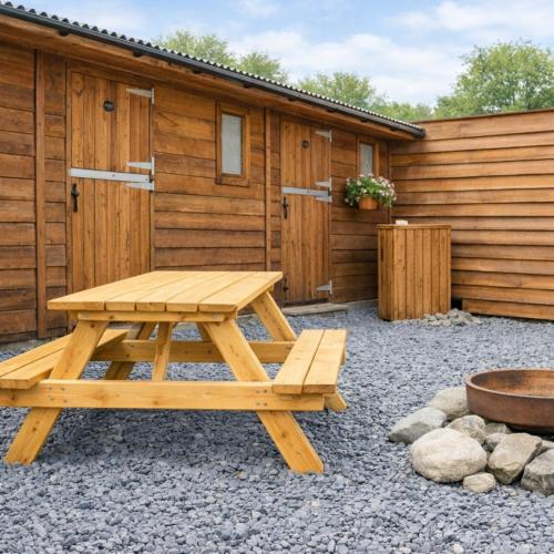 a picnic table in front of a cabin at Private Heated Bedrooms at The Bunkhouse in Snowdonia Perfect for Bikers and Walkers in Dolgellau