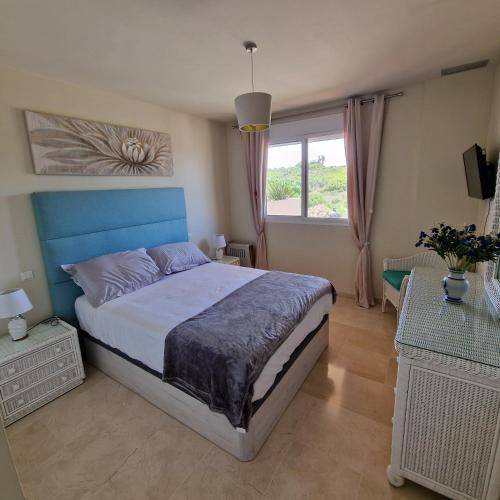 a bedroom with a large bed and a window at The Gaff in the Sun in Manilva
