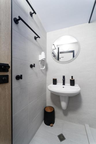 a bathroom with a sink and a mirror at Transilvaniya Apartments in Sozopol