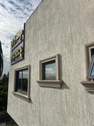 a building with two windows on the side of it at EL and LOUNGE in Accra