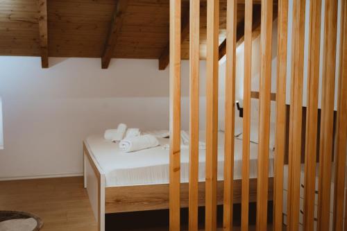 a bedroom with a bunk bed with wooden stairs at Vila Soleil in Vlorë