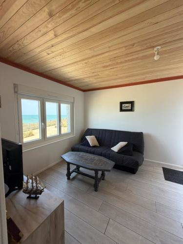 a living room with a couch and a table at La Bournonville in Ault