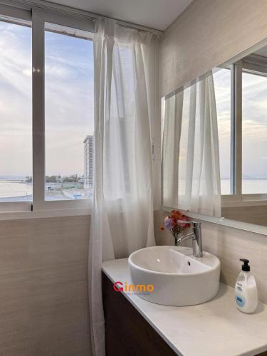 a bathroom with a sink and a large window at Chalet en el mar in La Manga del Mar Menor