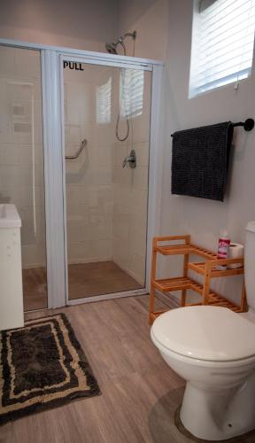 a bathroom with a shower with a toilet at The Dunes Haven studio in Keurboomstrand