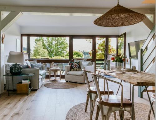 a living room with a table and chairs at Chiemgau Nest II in Siegsdorf