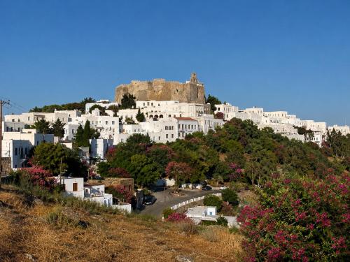 a city with a castle on top of a hill at Chora Heritage Residence by Belle-Stay in Patmos