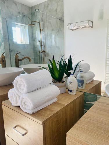 a bathroom with towels on a counter with a sink at Debres Apartment Aiud in Aiud
