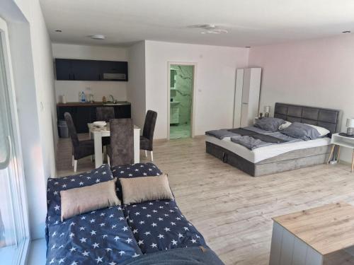 a living room with two beds and a couch at Apartman EC Milica in Stapar