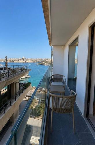 a balcony with a table and a view of the ocean at Sliema Centric Hotel in Sliema