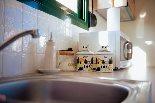 a kitchen counter top with a sink and a counter top with a sink at Iris apartment 1 in Anaxos