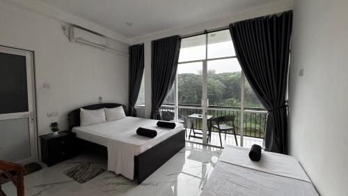 a hotel room with a bed and a balcony at Varsity Villa in Kandy