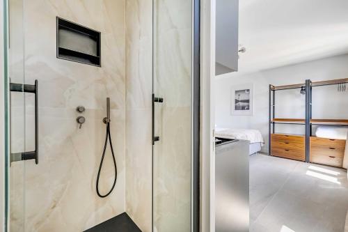 a shower with a glass door in a bathroom at Modern Studio 3P - Aubervilliers in Aubervilliers