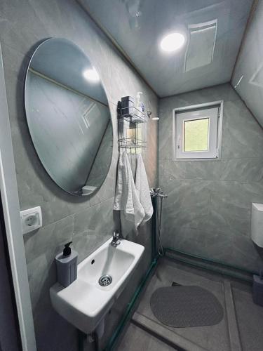 a small bathroom with a sink and a mirror at Ognjiste Komarnice in Komarnica
