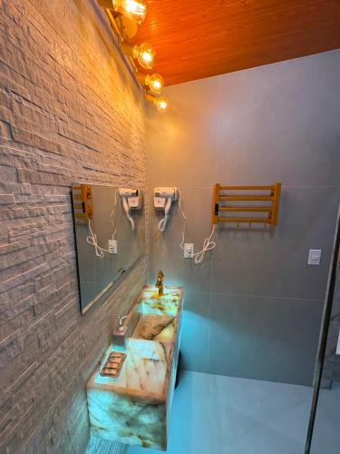a bathroom with a sink and a mirror at Chalé lago Azul in Venda Nova do Imigrante