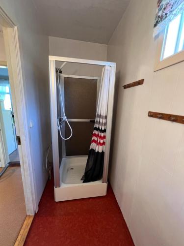 a bathroom with a shower with a shower curtain at Örnafälla in Örnafälla