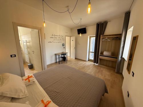 a bedroom with a bed and a desk in it at Agrialloggio Supramonte in Barisciano