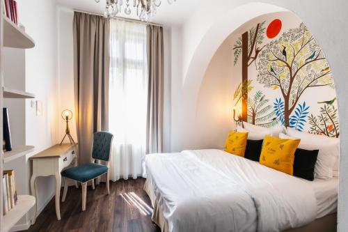 a bedroom with a large bed with yellow pillows at Mr Görgey Art Hotel in Visegrád