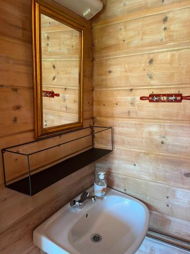 a bathroom with a sink and a mirror at Lystang Camping & Cabins in Notodden