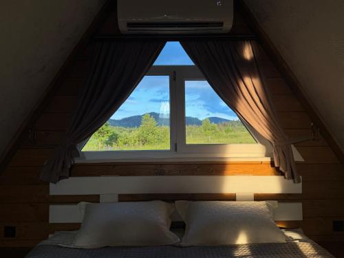 a window in a room with a bed in front of it at lovelaz820 in Khashchovanoye