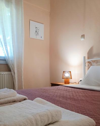 a bedroom with a bed and a window at Etherio in Makrygialos