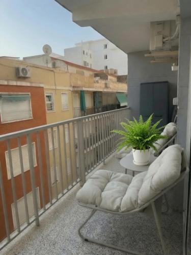 a balcony with a table and a plant on it at Cullera Beach III in Cullera