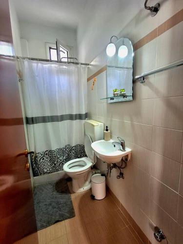 a bathroom with a toilet and a sink at Chrysa's Studios in Loutra Edipsou