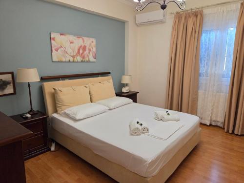 a bedroom with a bed with two stuffed animals on it at Birdsing Cottage in Dassia