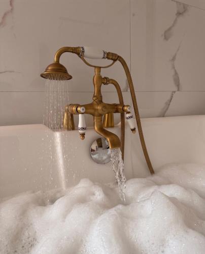 a bath tub with water coming out of a faucet at le petit château in Chambéry