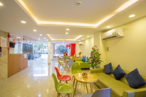 a lobby with a couch and chairs and tables at Camila Hotel in Ho Chi Minh City